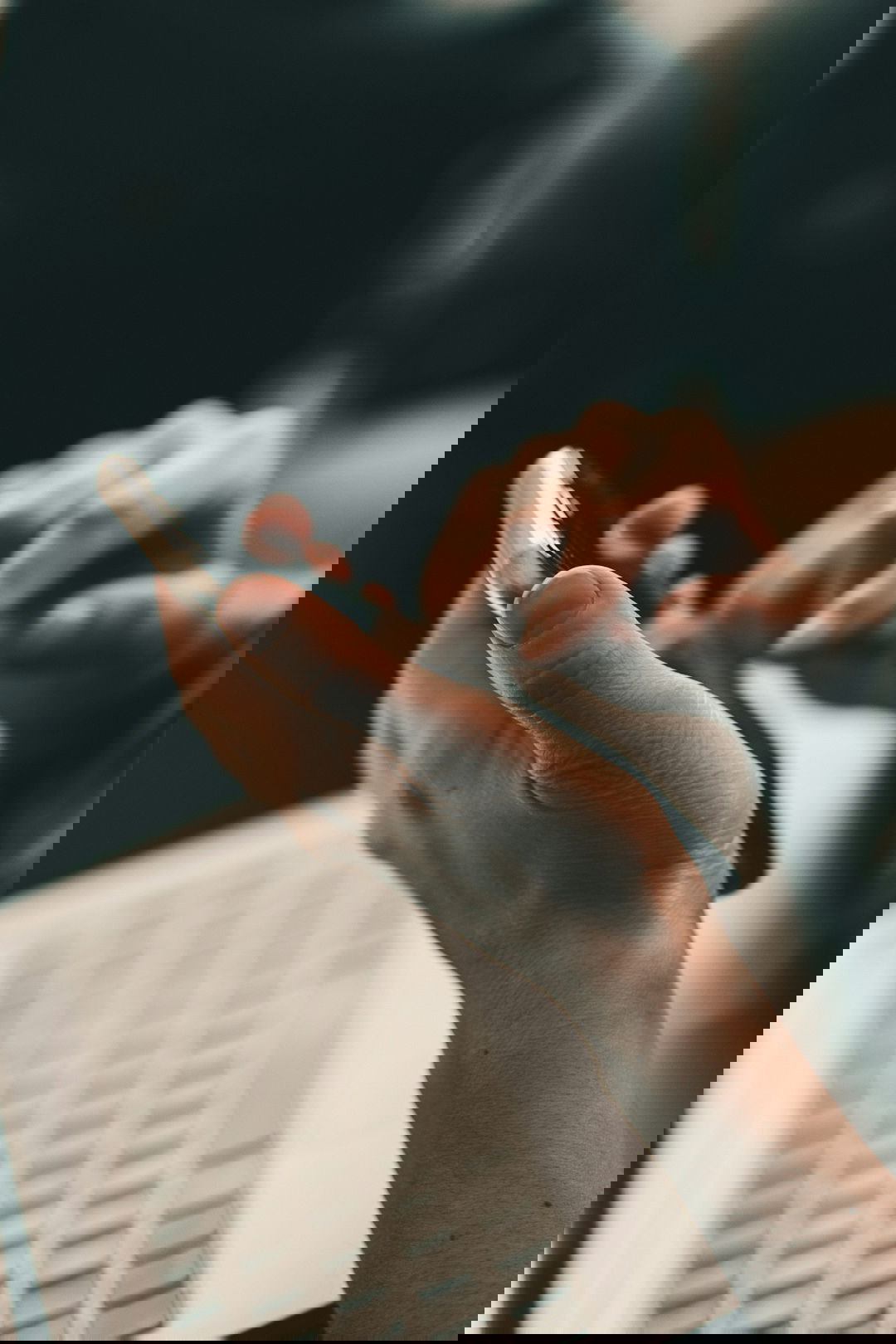 person-holding-black-and-white-pen.jpg person holding black and white pen